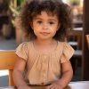 little-girl-with-curly-hair-sitting-table